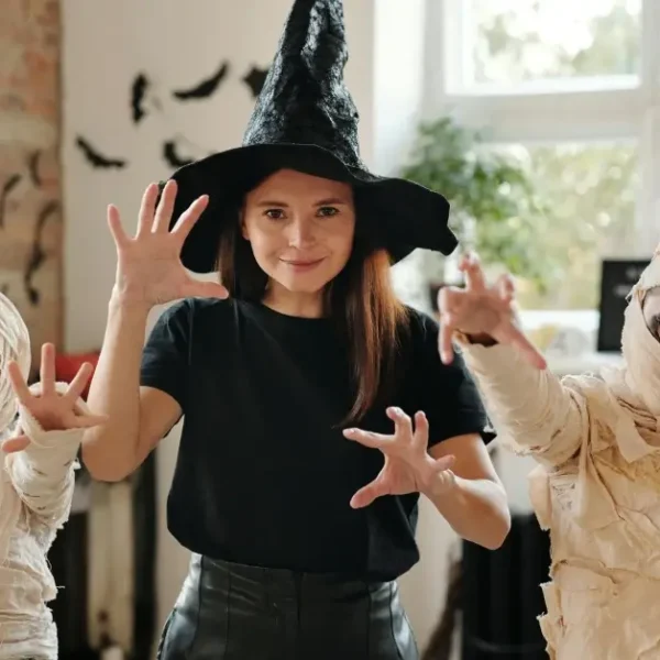 Women and two kids creating diy carnival outfits being a mummy figure