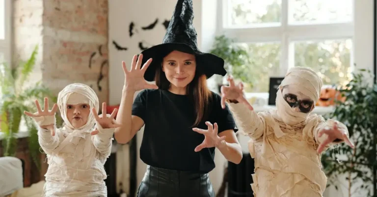 Women and two kids creating diy carnival outfits being a mummy figure