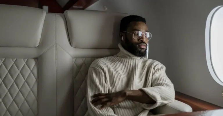 Men Travel Outfits Wearing White Turtleneck on a Plane